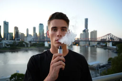 Vape gear being placed in a delivery box with a Brisbane map in the background.